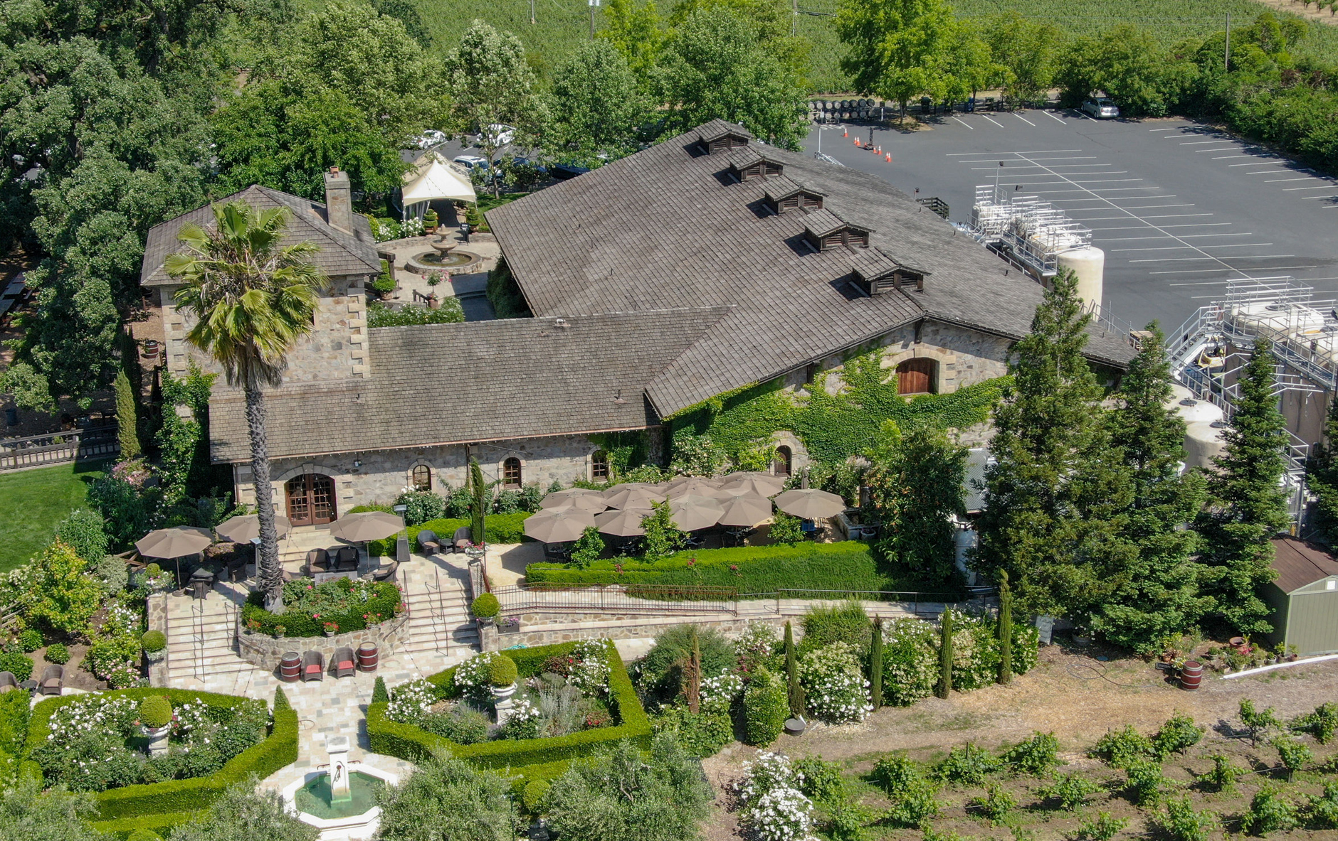 External view of stylish family house with fence, garage, stone driveway and garden, panorama